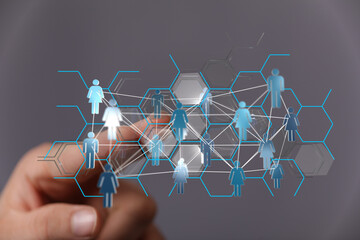Hand touching a network of connected people. Concept of teamwork, social connection, digital transformation and