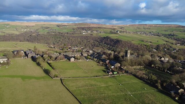high aerial view of the village of heptonstall in calderdale showing the church and streets surrounded by west yorkshire landscape