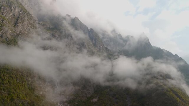 Remote alpine wilderness in the Dolomites under low clouds, Italy