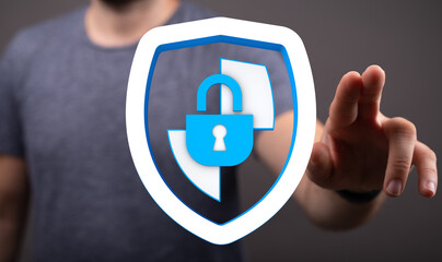 A person's hand interacting with a digital security shield, symbolizing protection, privacy, and...