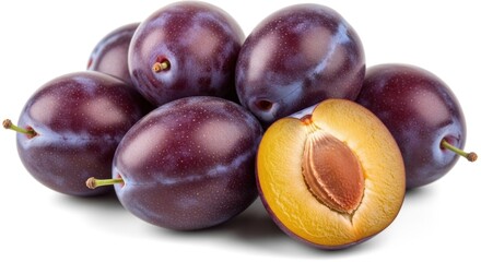 Obraz premium A pile of plums with one cut open to reveal the pit.
