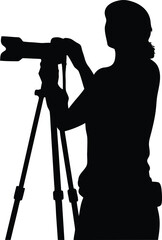 Professional photographer silhouette operating a camera on a sturdy tripod ready to capture stunning moments