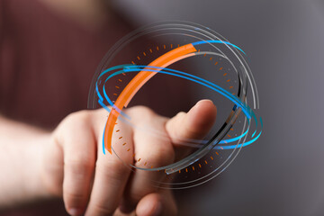 Person's finger interacting with a holographic globe graphic.  Digital networking concept, futuristic interface and global connection