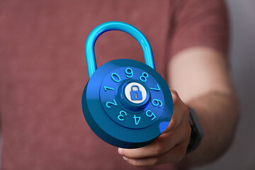 Close up photo of person holding a digital blue combination lock. Symbol of security, privacy and protection. B