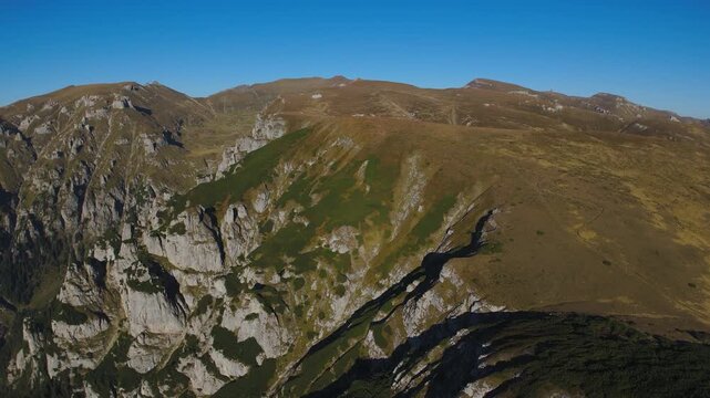 Aerial Lateral Parallax Orbit Revealing Scara and Lancia Peaks at Sunset