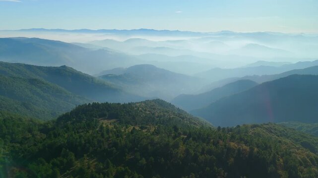 Bright sunlight over foggy Italian valley landscape