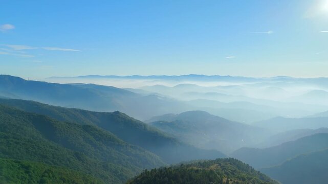 Scenic foggy valley illuminated by sunlight in Italy