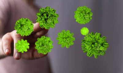 Conceptual image of green viruses approaching a hand, illustrating the concept of a pandemic or...