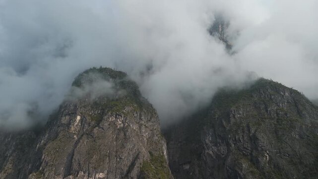 Dolomites mountain peaks with clouds overlooking scenic valley, Italy