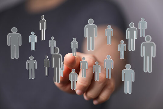 Hand pointing at a collection of people icons, representing the concept of human connection and a business netw - Powered by Adobe