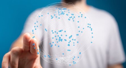 A person's hand touching a network globe illustration representing technology and global connection, with focus on modern digital con