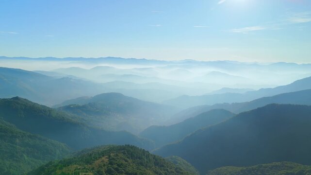 Sunlit fog over scenic Italian valley, Ceranesi region