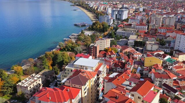 Aerial video of Pogradec, Albania, overlooking Lake Ohrid and the city waterfront.