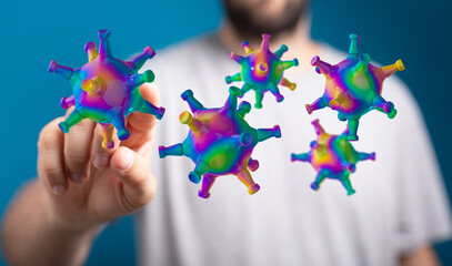 Artistic rendering of colorful virus particles with a hand reaching out. Symbolic representation of concepts l