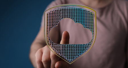 Hand pointing towards a digital cloud shield icon, symbolizing cloud computing, data protection, and internet security. Represents on