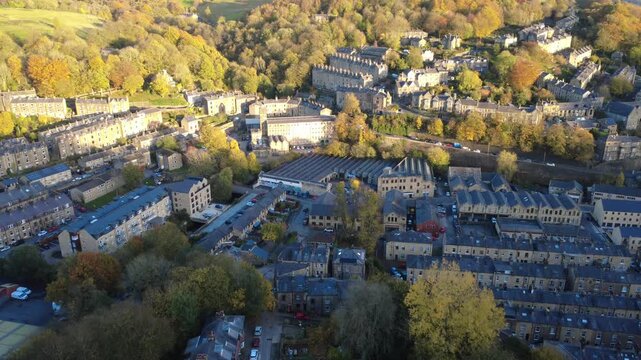aerial view of the town of Hebden Bridge in autumn sunlight showing streets of houses