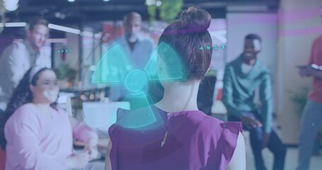 Leading woman with bun in magenta blouse addressing team in office, projecting trefoil hologram