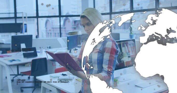 Reading woman wearing plaid shirt holding red notebook in open-plan office with world map overlay - Powered by Adobe