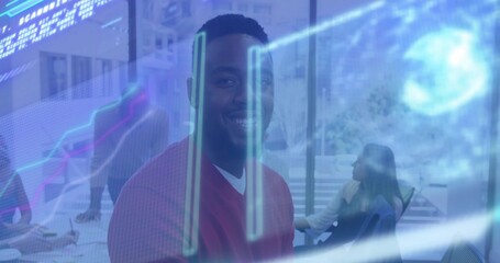 Smiling man in red sweater and white shirt facing camera in conference room, with AR graphs