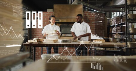 Holding wooden trays, two chefs wearing chef coats arranging loaves in bakery, digital overlays