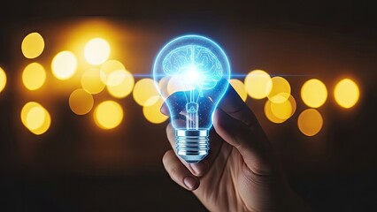 Innovative hand holding glowing light bulb with brain inside