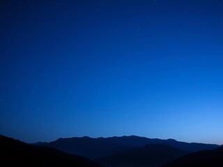 Dark to light blue gradient night sky with star dots and mountain silhouettes,  calm,  mountains