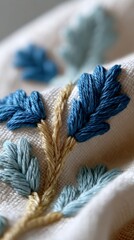 Richly textured blue and teal embroidery evokes a cozy hygge atmosphere, perfect for Heritage Week or Thread the Needle Day