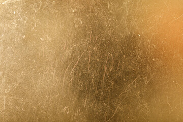 Abstract golden background with subtle texture and scratches, ideal for luxury designs, websites,...