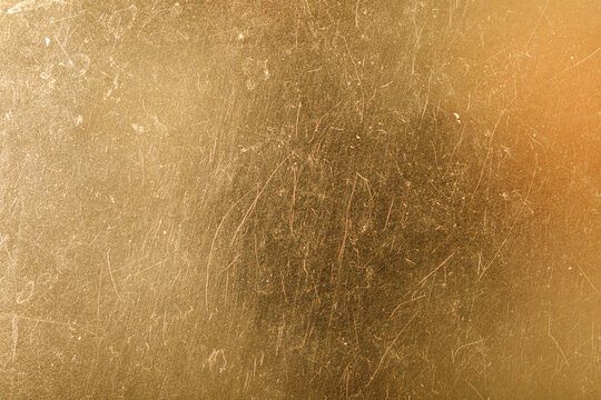 Abstract golden background with subtle texture and scratches, ideal for luxury designs, websites, or elegant p