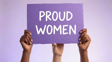 Diverse female hands raising purple sign with the text "proud women" on purple studio background