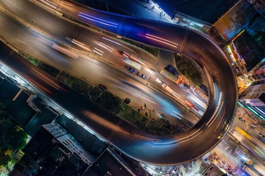 Aerial view of the vibrant city streets and illuminated highways come alive with streaks of light, Dhaka, Dhaka Division, Bangladesh.