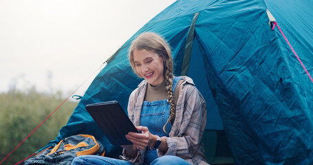 Smile, woman and camping with tablet outdoor for research, watching movies and weather forecast. Person, reading or tent with digital on vacation, browsing internet and online entertainment in nature