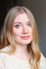 Close up portrait of smiling woman with blue eyes calm expression and natural feminine look
