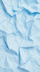 Light blue crumpled paper surface displaying intricate texture, revealing complex folds, subtle shadows, and wrinkled abstract background