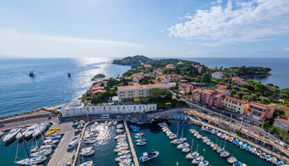 Aerial view of boats clustered in the marina contrasting with the vibrant buildings and clear blue sea, Marseille, Provence-Alpes-Cote d'Azur, France.
