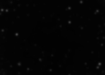 Falling snowflakes out of focus on black background for overlay blending mode. Snowing, snowfall, snow on black background, selective focus