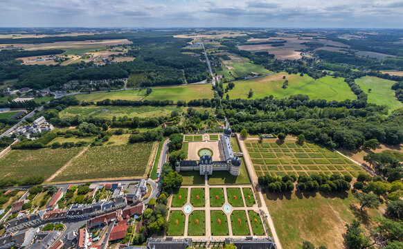 Aerial view of Chateau de Chaumont, a majestic castle surrounded by geometrically arranged gardens and lush green fields, Chaumont-sur-Loire, Centre-Val de Loire, France.
