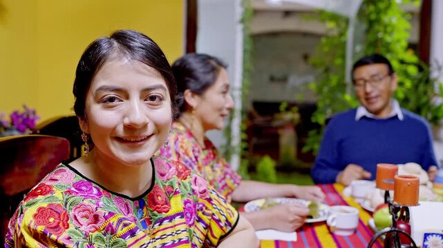 Close-up portrait of a beautiful woman of the Mayan ethnicity, wearing a beautiful outfit with vibrant colors.