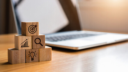 Wooden blocks with on a desk next to a laptop transparent background target magnifying