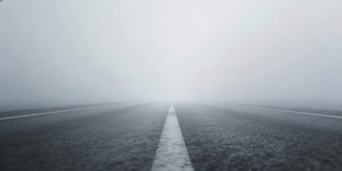 Misty road stretches into the distance with bright light ahead