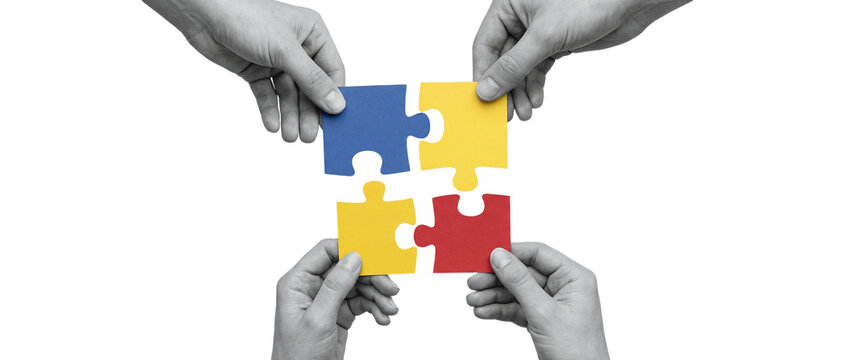 Four hands holding colorful jigsaw puzzle pieces connecting together, symbolizing teamwork and collaboration on a transparent background