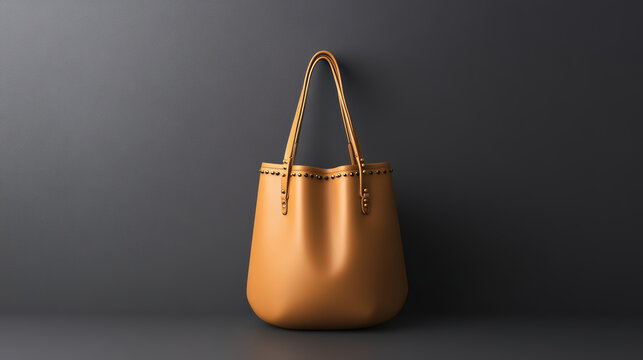 Leather tote bag tan minimalist studio soft light modern elegant luxury fashion accessory fill frame with warm, refined mood, smooth texture, and subtle metal studs along rim