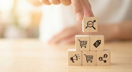 Close up of an adult hand placing a megaphone icon wooden block on top of a marketing strategy pyramid indoors, representing business growth and digital communication concepts in a bright studio.