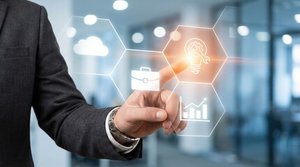 Close up of a White adult man in a professional suit touching a glowing digital lightbulb icon on a hexagonal interface in a modern office, representing innovation and business strategy.