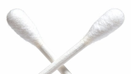 Two sterile cotton swabs crossed against a white background, close-up studio shot