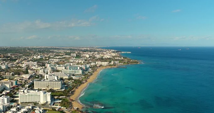 Drone aerial panorama of Protaras coastline with beaches, hotels and turquoise Mediterranean Sea
