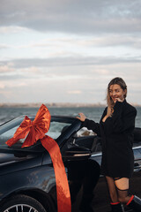 Happy Woman Receiving a Car as a Gift