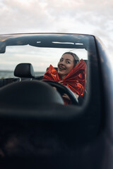 Happy Woman Receiving a Car as a Gift