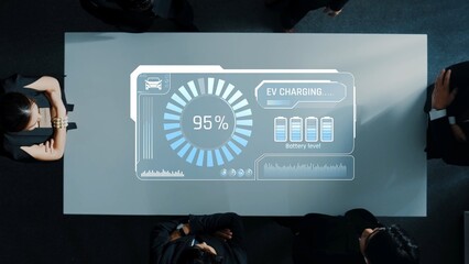Business professionals gather around a sleek table, analyzing EV charging data displayed on a digital interface, highlighting battery levels and progress indicators. Raster