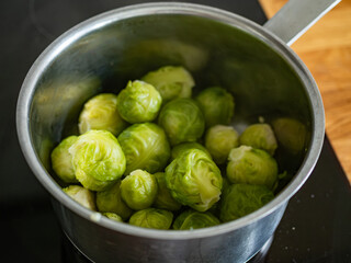 Cooked Brussels sprouts in pot on electric stove